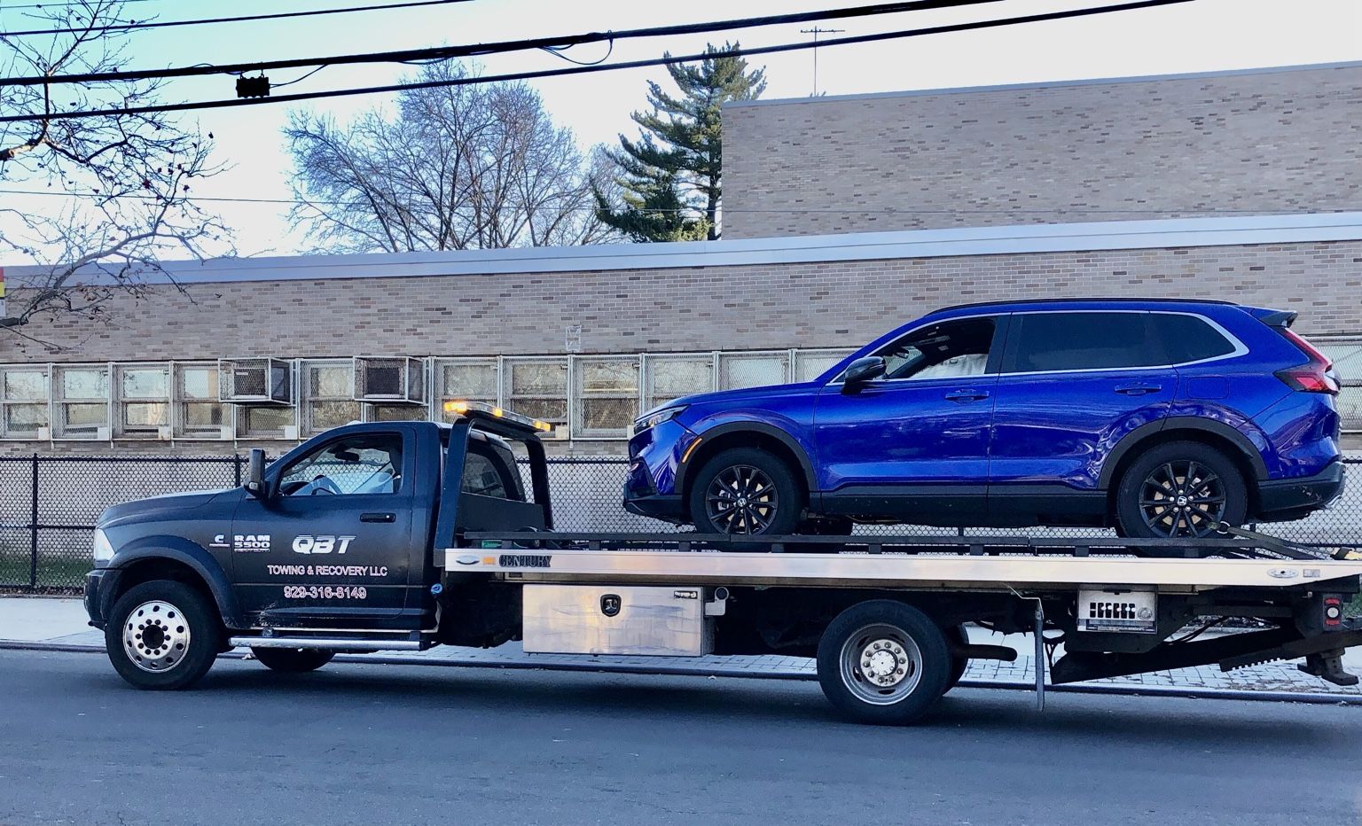 QBT truck transporting vehicle on flatbed