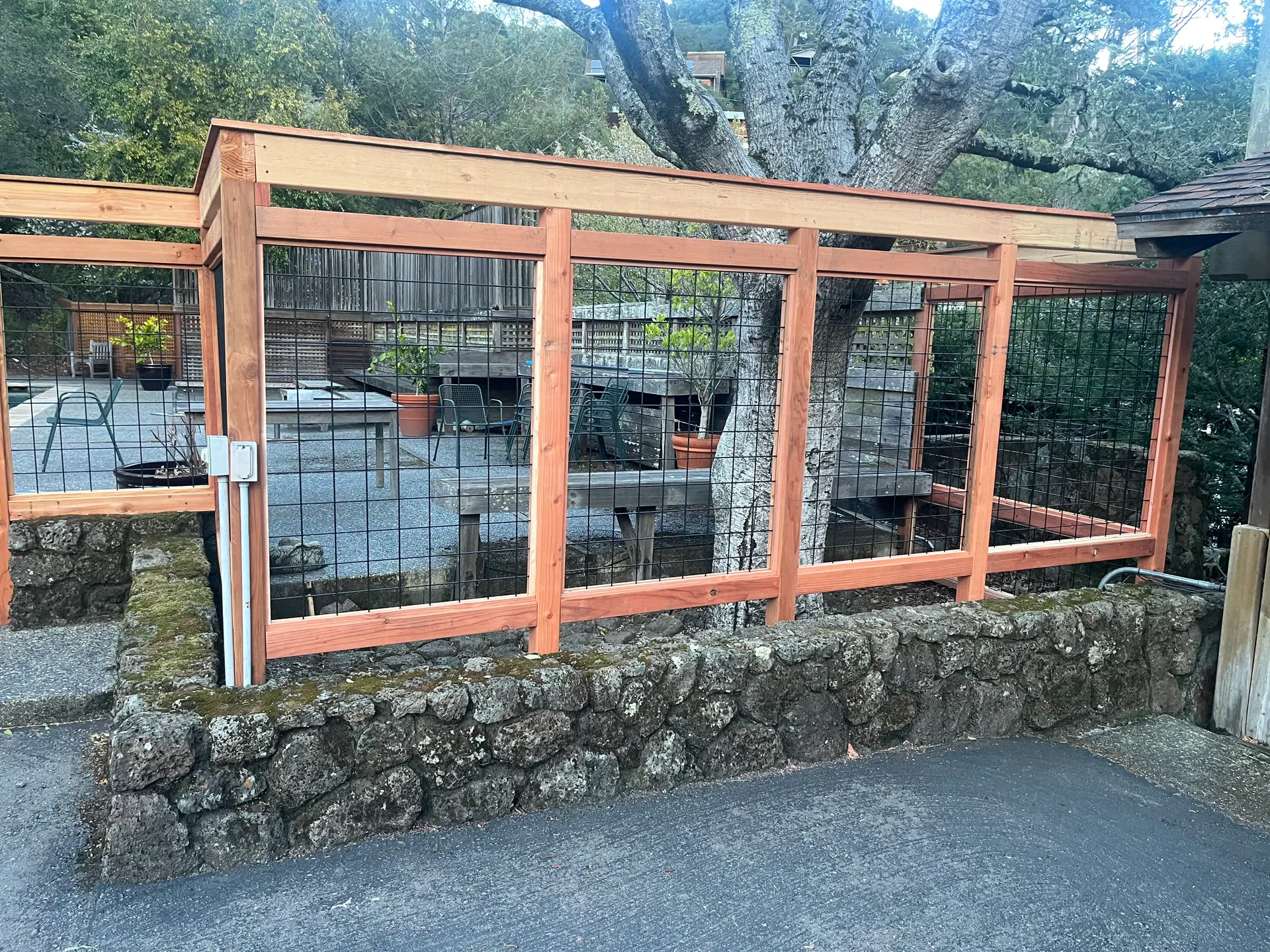 Custom wood fence and stone base by Garcia's Landscaping