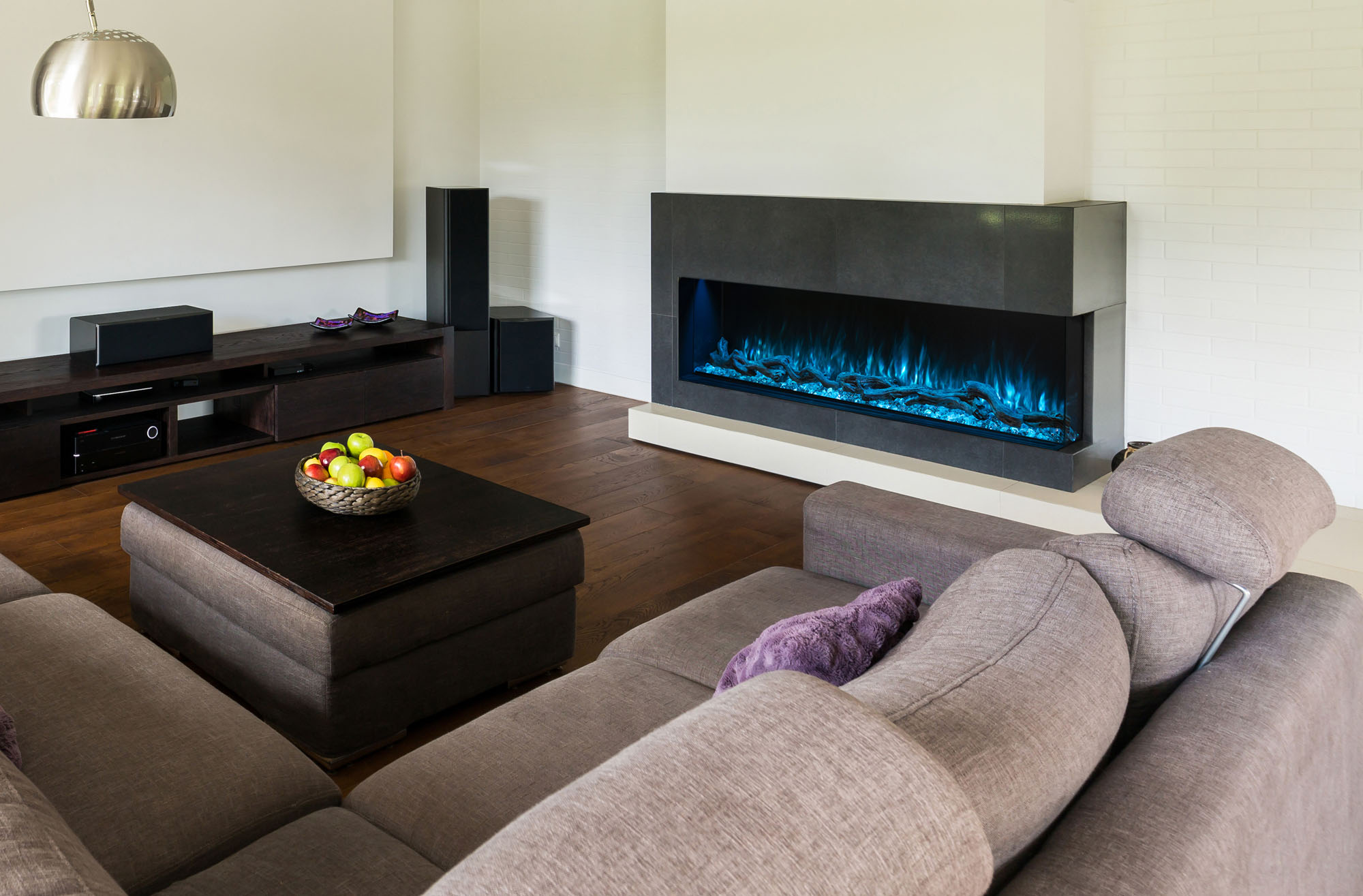 Modern linear electric fireplace with colorful LED flames in a living room