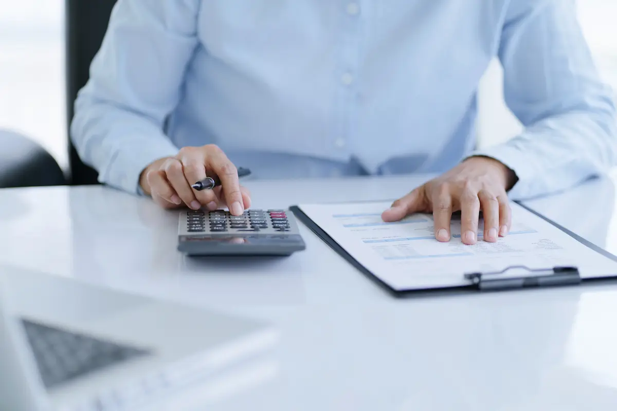 Professional accountant analyzing financial charts and documents at a desk