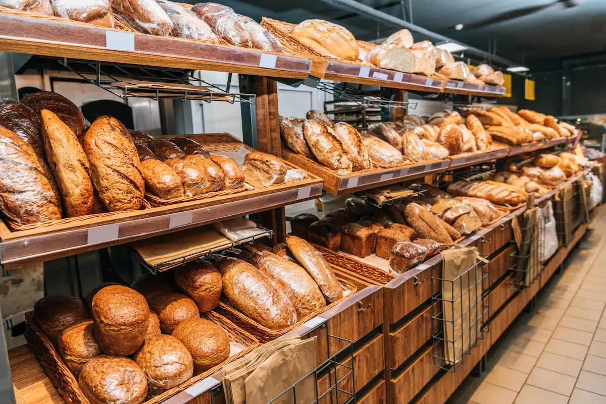 Close view of freshly baked breads and pastries displayed at a bakery