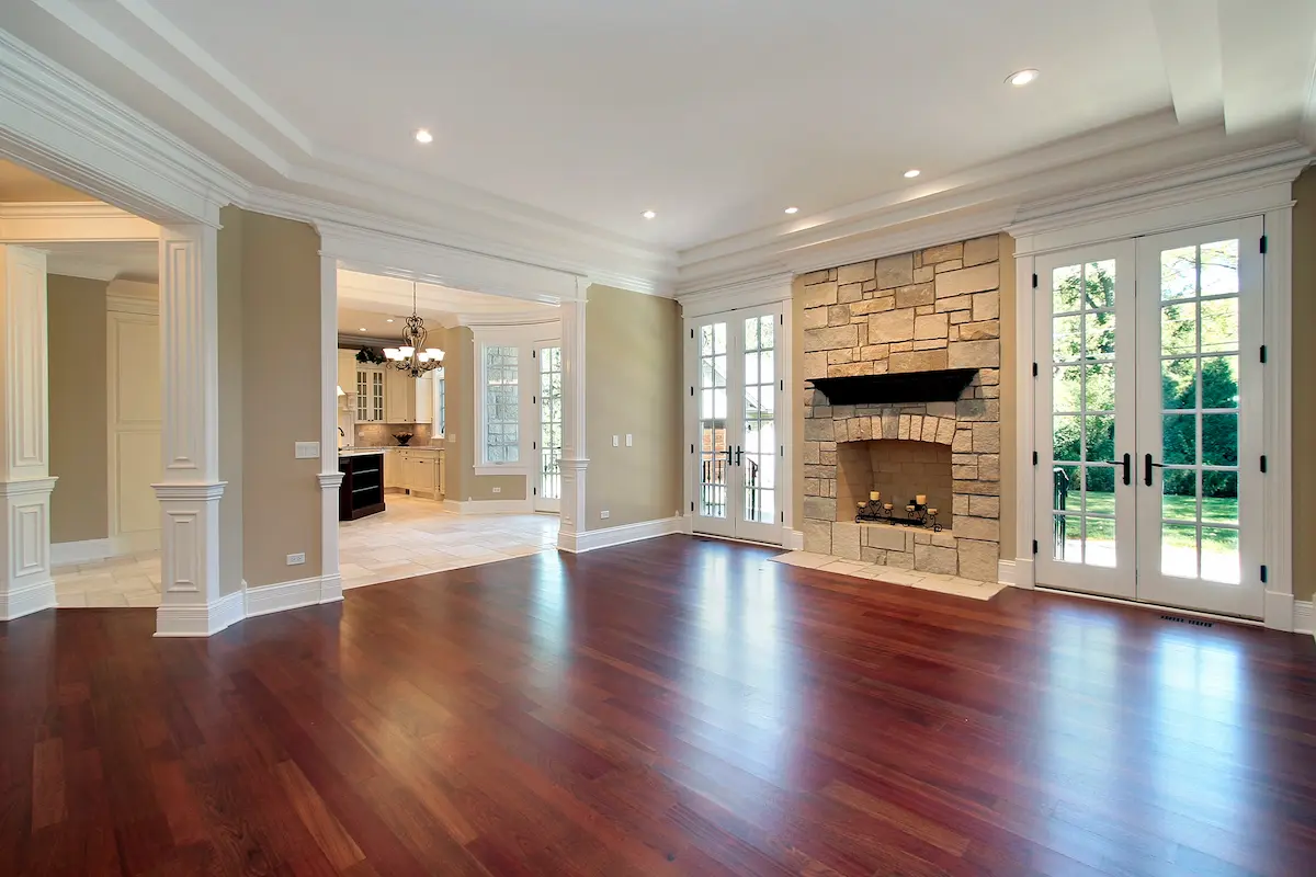 Elegant living room featuring rich hardwood floors and a stone fireplace