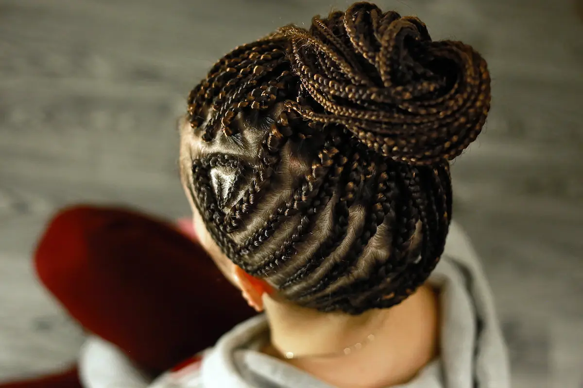 Intricately styled African braids gathered into a patterned updo