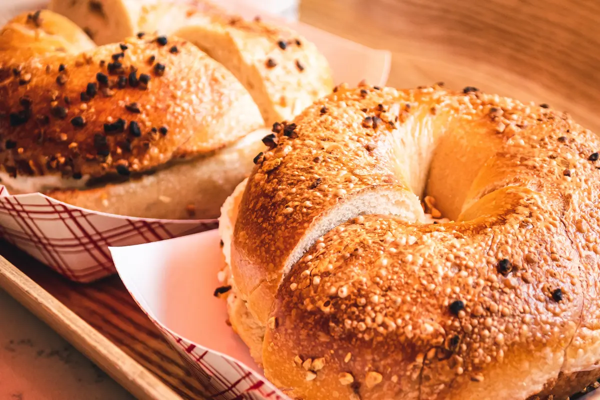 Freshly baked New York style bagels with sesame and poppy seed toppings served with cream cheese spread and lox