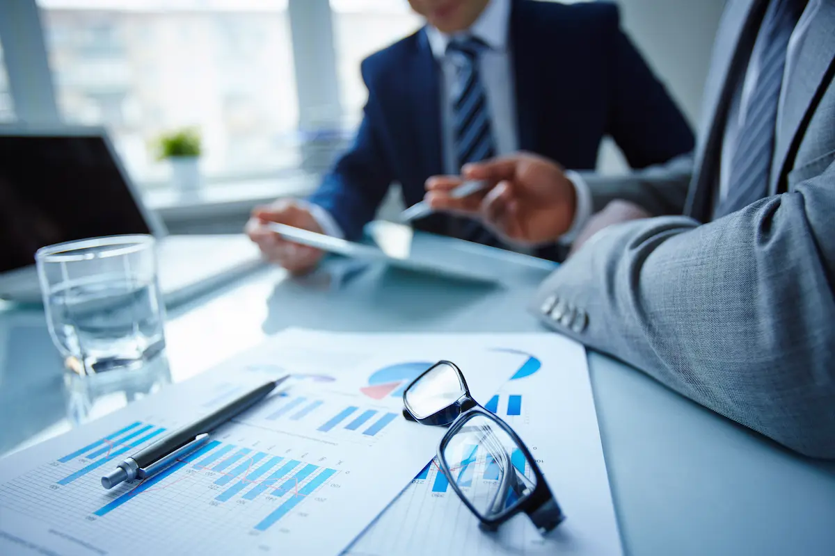 Business lending consultation meeting with professionals reviewing financial documents at a conference table