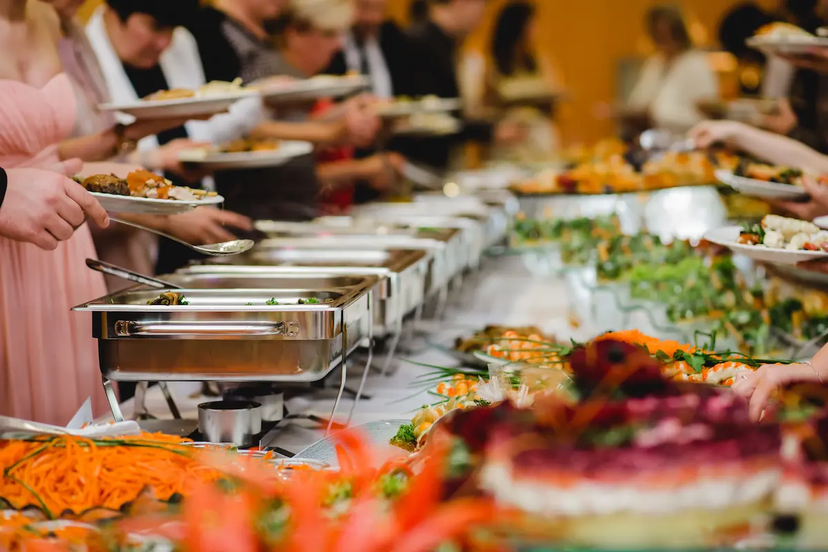 Elegant catering wedding buffet with beautifully presented food displays and professional service setup for a catered event