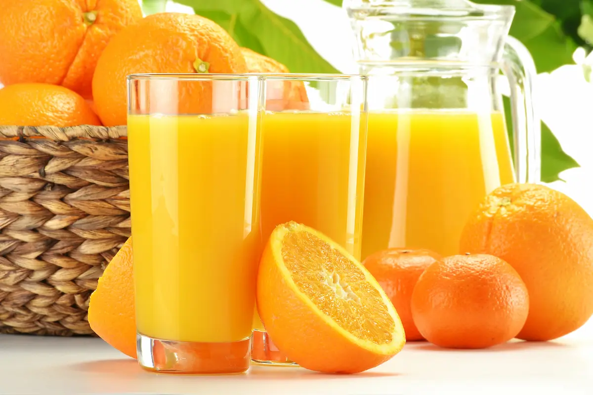 Fresh vitamin-rich orange juice and fruits representing the wellness and nutritional focus of IV vitamin therapy infusion clinics