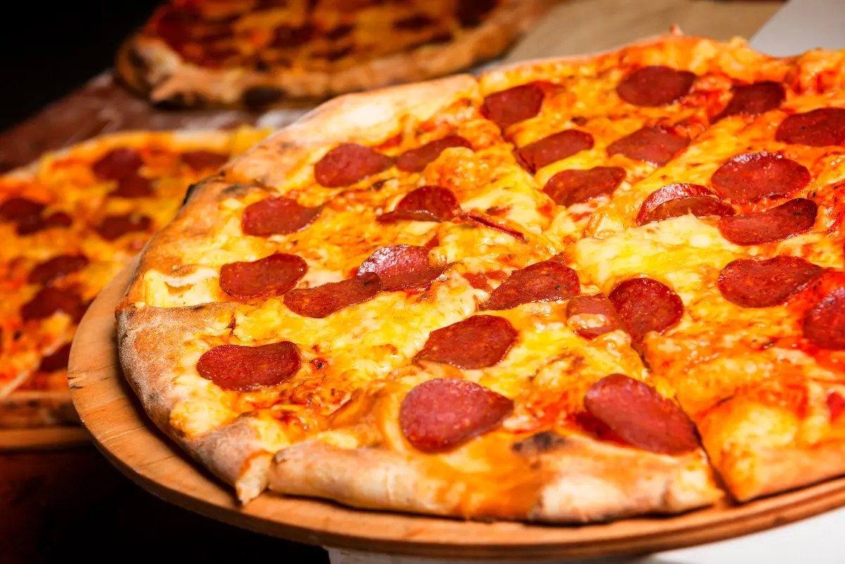 Fresh authentic Italian pizza with melted cheese and toppings representing a classic pizzeria menu