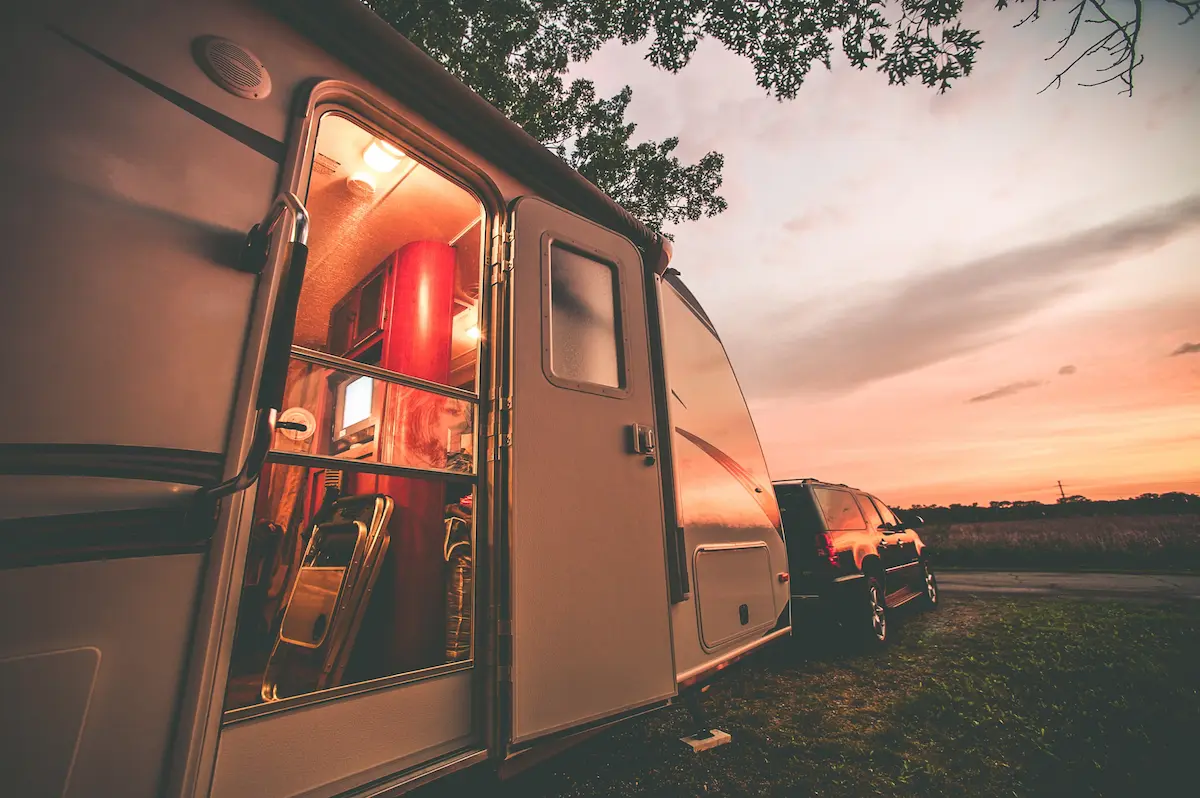 Travel trailer parked at a campsite representing a welcoming RV park and camping destination for road travelers