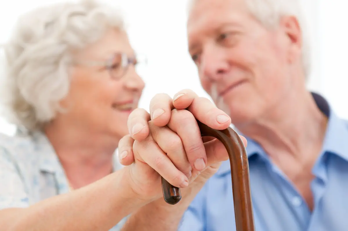 Serene senior couple representing the warmth and dignity of life with Parkinson's disease and the importance of community support for carers