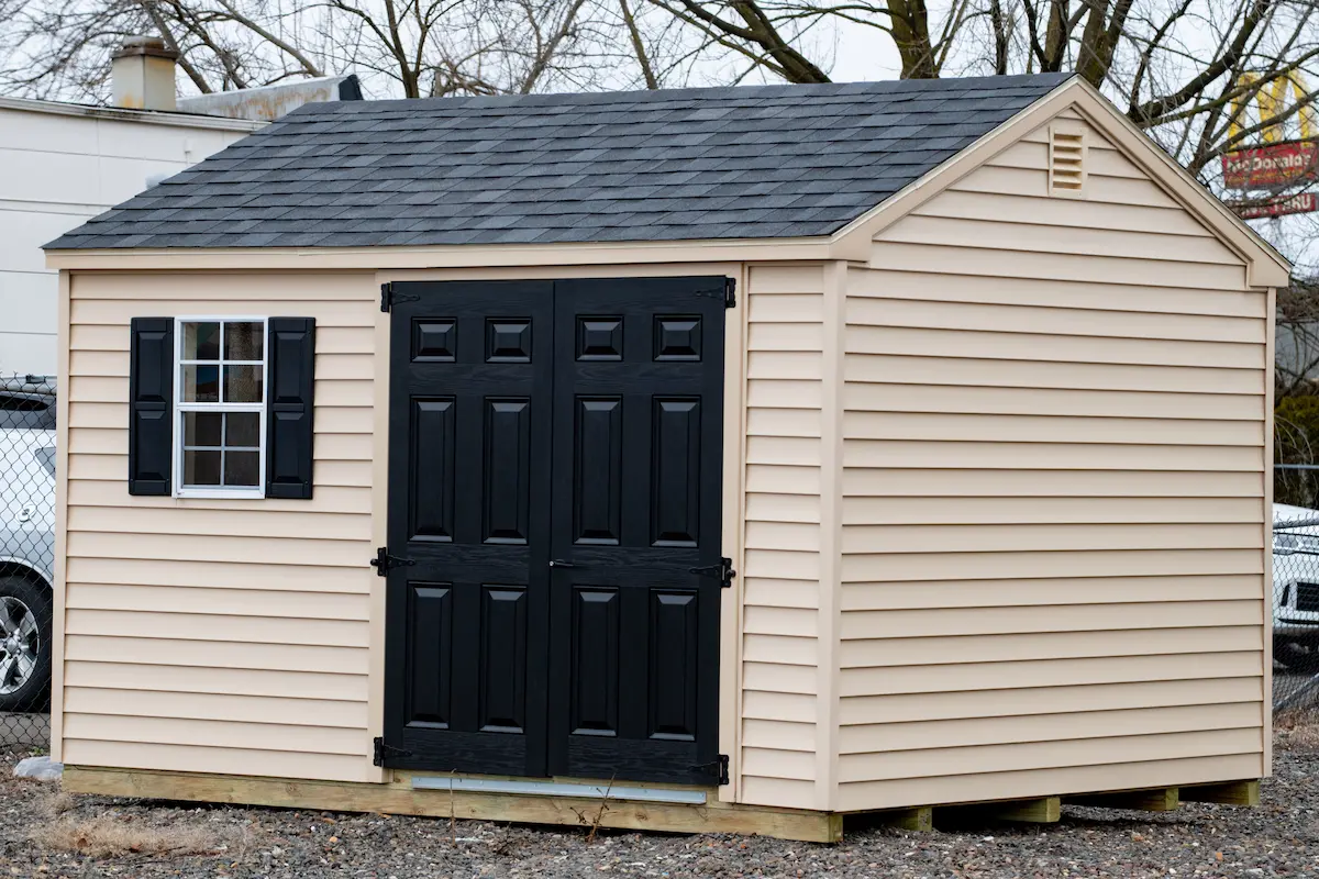 American-style wooden shed with door and window representing quality portable building and outdoor storage structure products