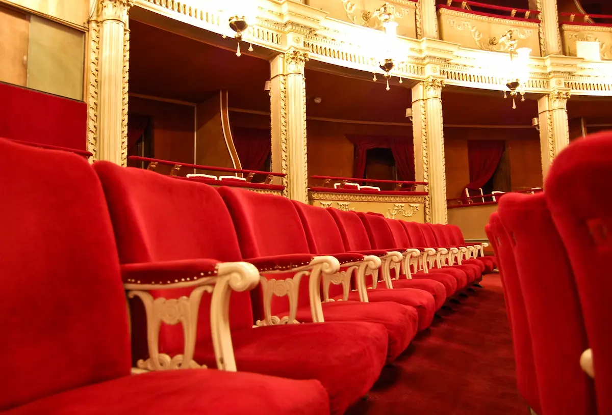 Grand opera house interior with ornate architecture and rows of seating representing the cultural significance and elegance of the operatic tradition that opera guilds exist to support and sustain