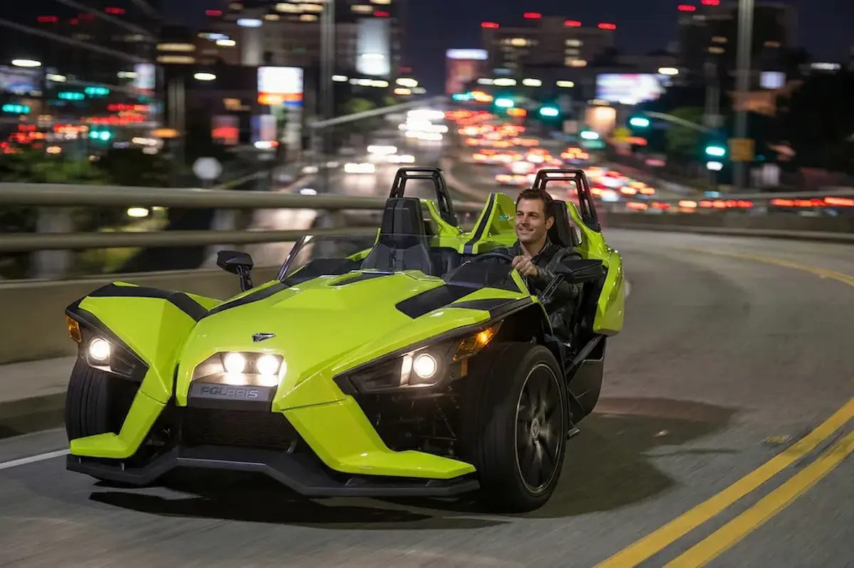 Polaris Slingshot three-wheeled open-air vehicle ready for rental representing the thrilling and unique driving experience that slingshot rental companies provide for tourists and adventure seekers