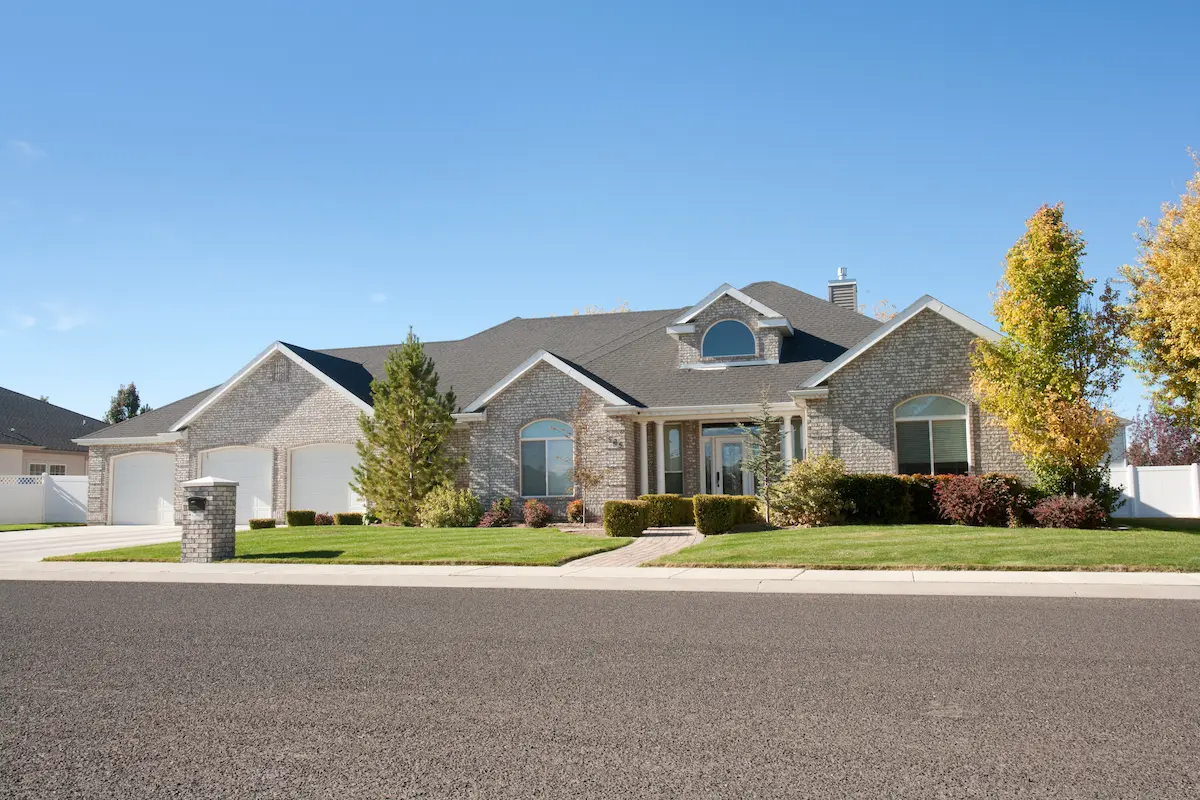 Suburban brick home representing the residential rental properties that a professional property management company oversees on behalf of owner clients