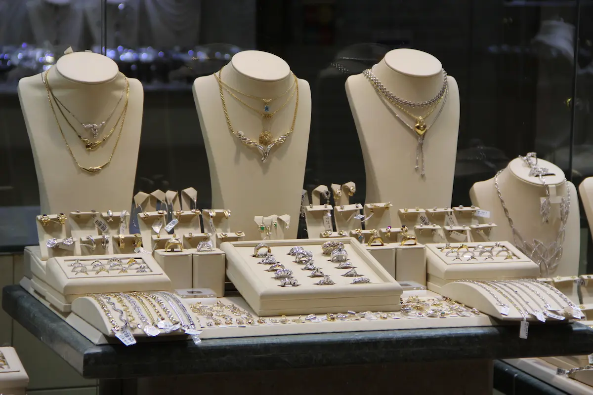 Fine jewelry displayed in a shop window showing rings, bracelets, pendants, and watches representing the collection depth and quality that an independent jewelry store offers
