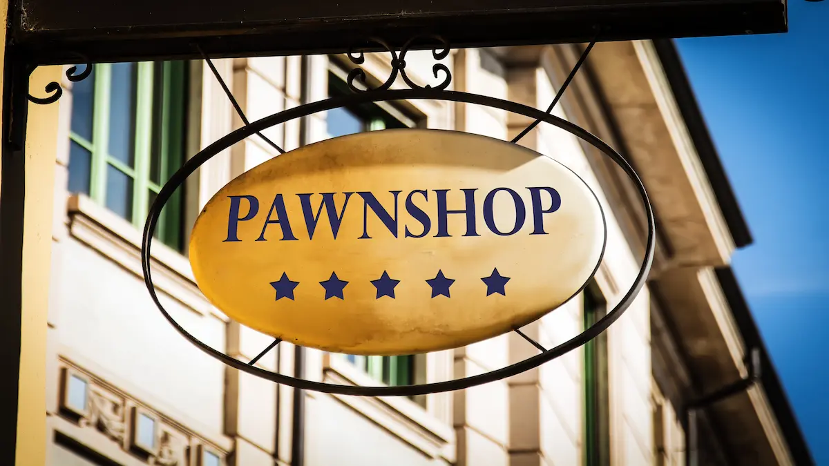 Street sign pointing the way to a pawnshop representing the local visibility and accessibility that a well-ranked pawn shop website provides to every customer in the area