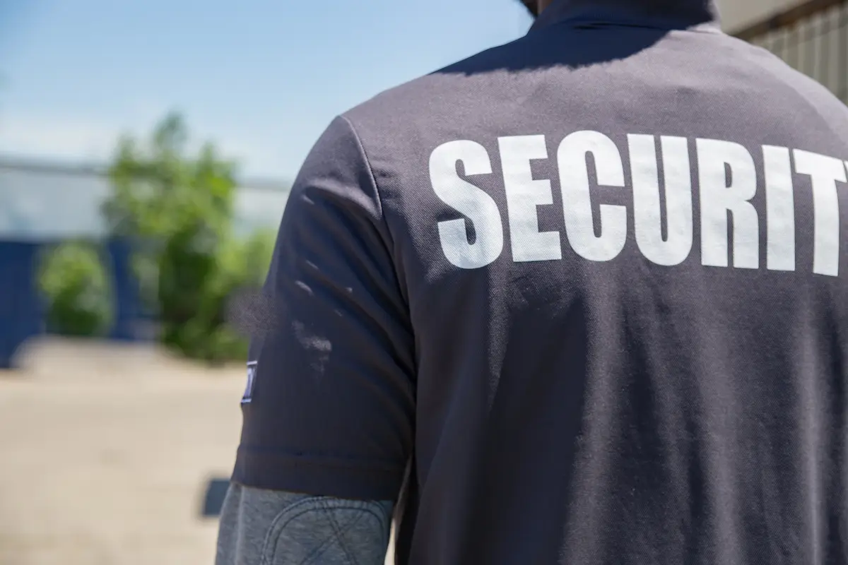 Security officer monitoring a parking area representing the professional and vigilant security guard services that a licensed security company provides for commercial and residential properties