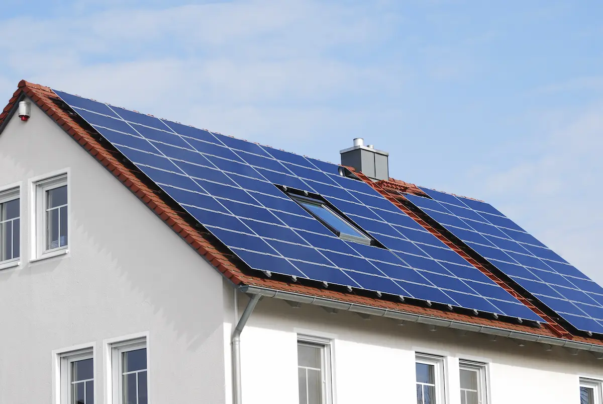 Modern home with solar panels installed on the roof representing the professional residential solar energy systems that a qualified solar installation company provides for homeowners seeking energy independence and utility cost reduction