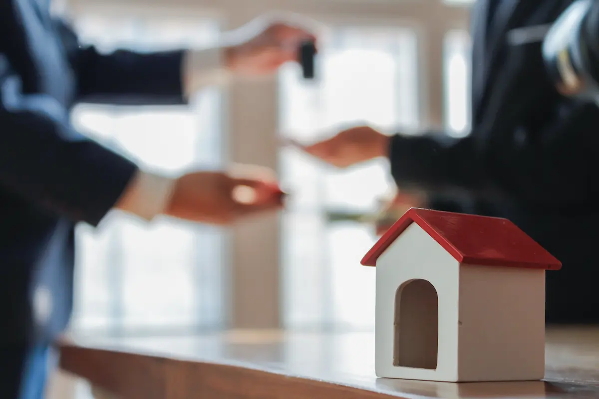 Real estate investors planning and reviewing sales statistics on a property overview representing the professional and organized real estate investment business that a credible house buying company operates