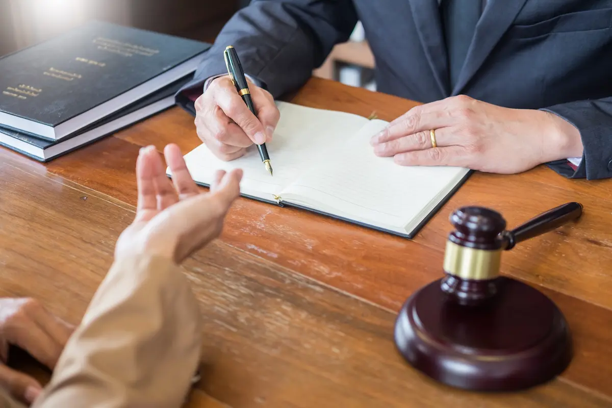 A lawyer in an office counseling and giving legal advice to a client representing the professional and client-focused representation that a trusted personal injury attorney provides
