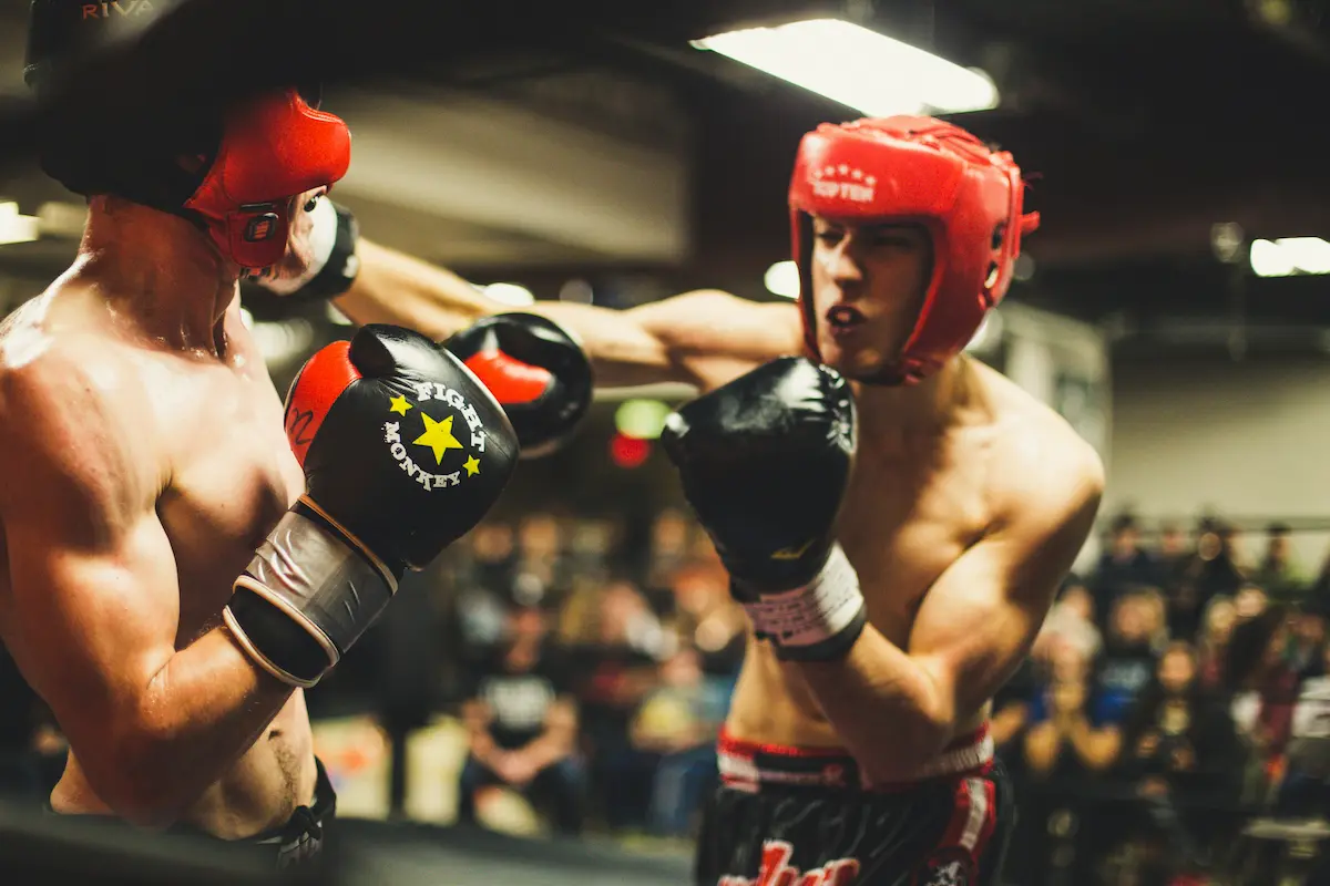A kickboxing class in action representing the high-energy training environment, skilled instruction, and motivating community that a great kickboxing studio provides for members at every level