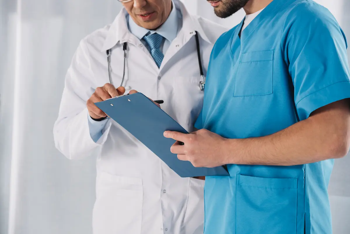 A physician in a clinical setting representing the medical practices and eligible clinicians whose MIPS participation requirements and quality payment program reporting obligations are managed by a professional MIPS reporting service