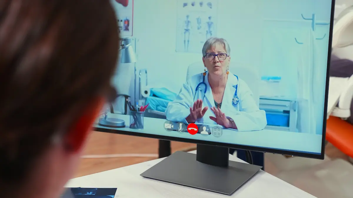 A healthcare professional conducting a remote clinical consultation via webcam representing the secure telehealth technology and professional clinical care delivery that a prison telepsychiatry service provides to correctional facilities and their incarcerated patient populations
