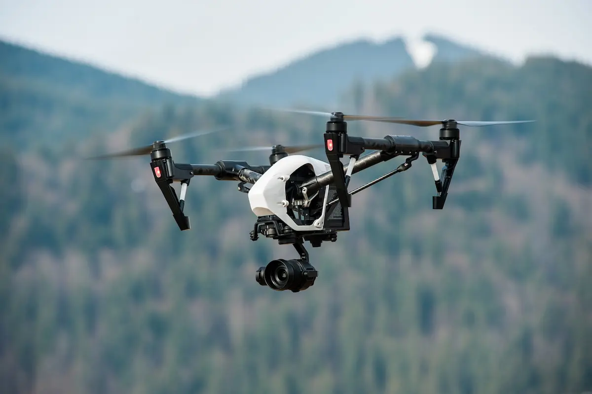 A professional agricultural drone equipped with a high-resolution camera and application system representing the precision, efficiency, and technical capability that a certified aerial drone applicator brings to crop spraying, herbicide application, and land management services