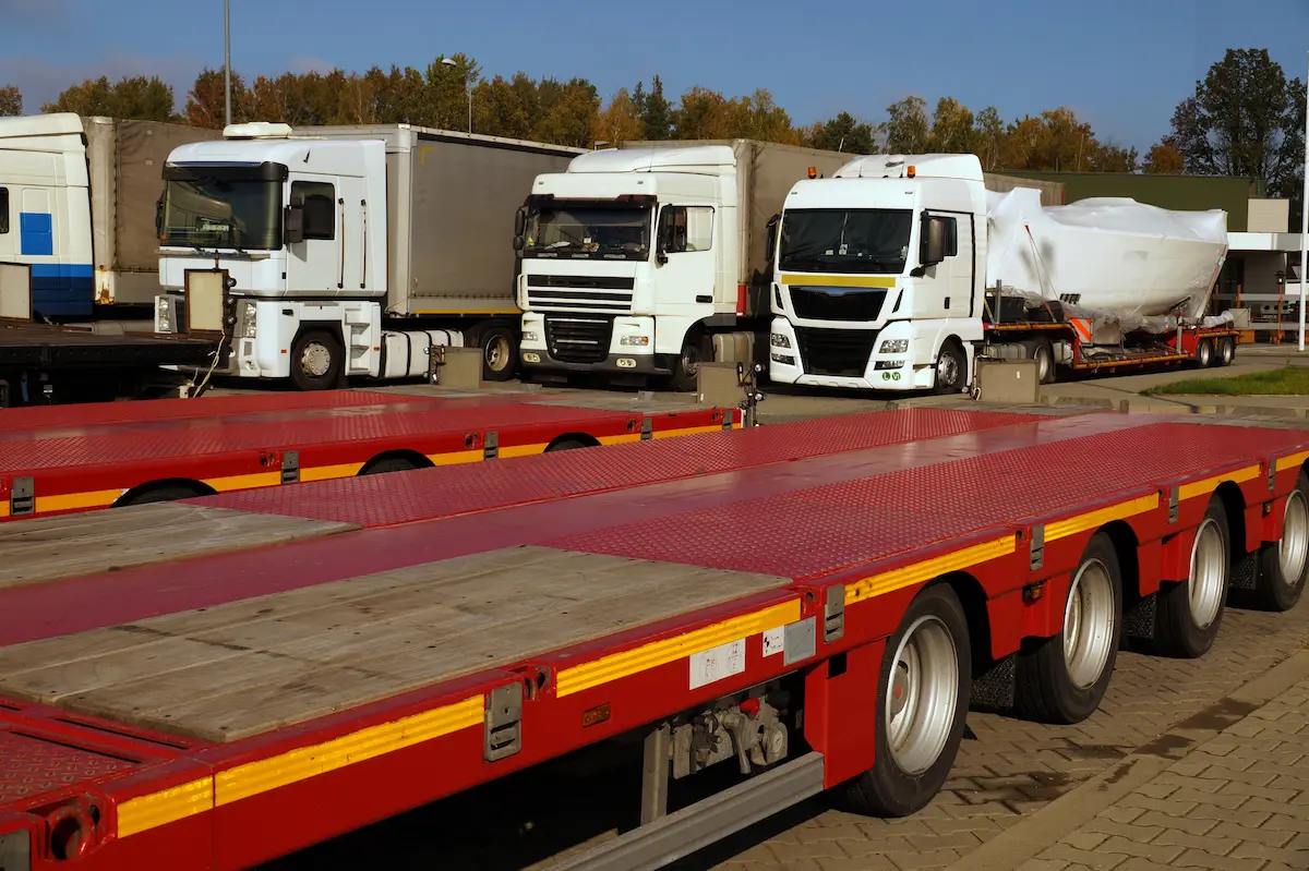 A fleet of commercial trucks and construction vehicles parked in a service yard representing the heavy-duty commercial vehicles, fleet operations, and professional truck maintenance work that a qualified mobile truck repair service handles for owner-operators, fleet managers, and logistics companies
