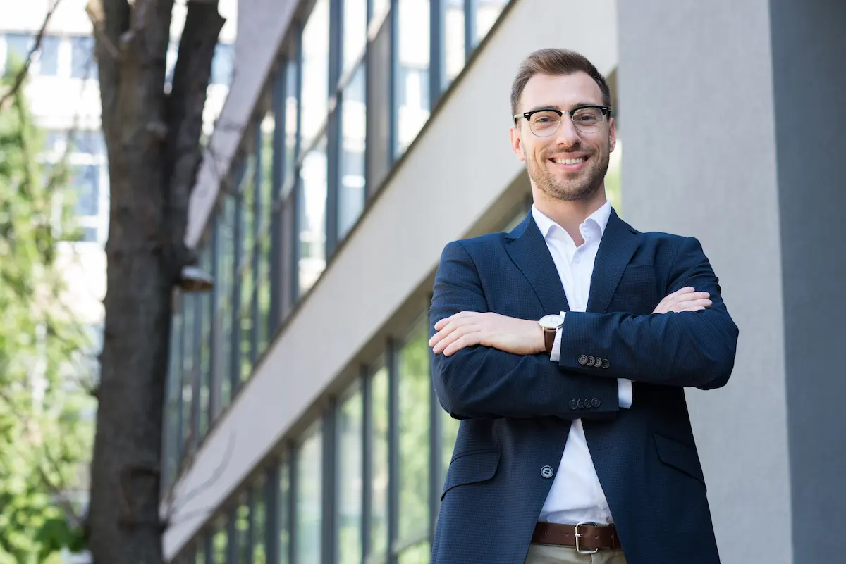 A confident professional businessman in formal wear with crossed arms representing the executive presence, professional credibility, and authoritative positioning that a skilled authority development agency builds for every client seeking to establish thought leadership and industry recognition