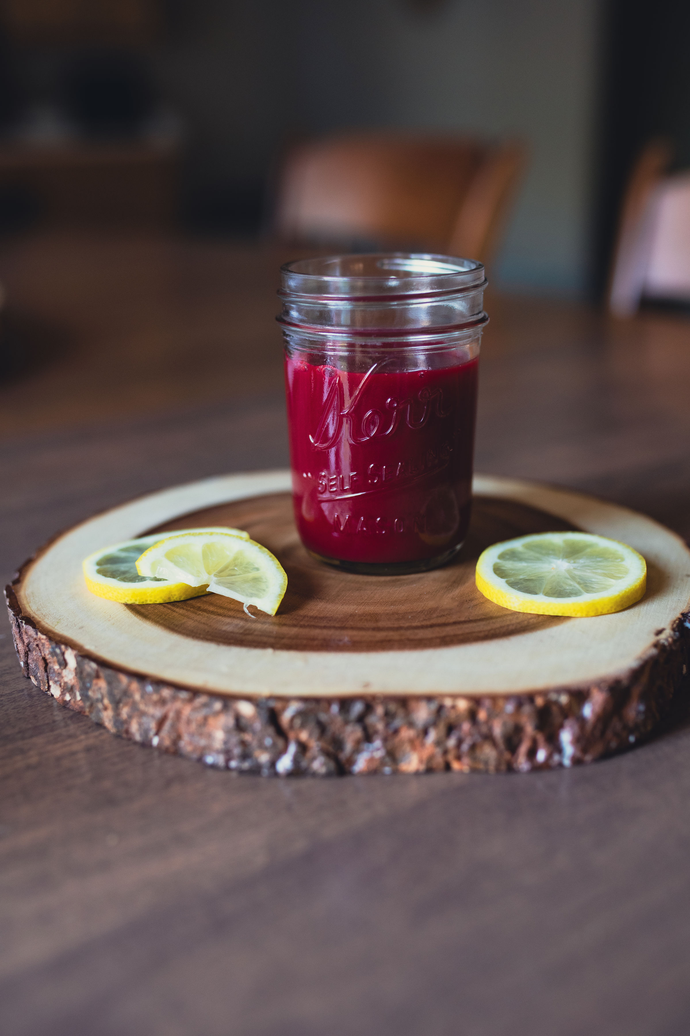 ABC juice — deep red apple, beet and carrot juice in a glass jar with lemon
