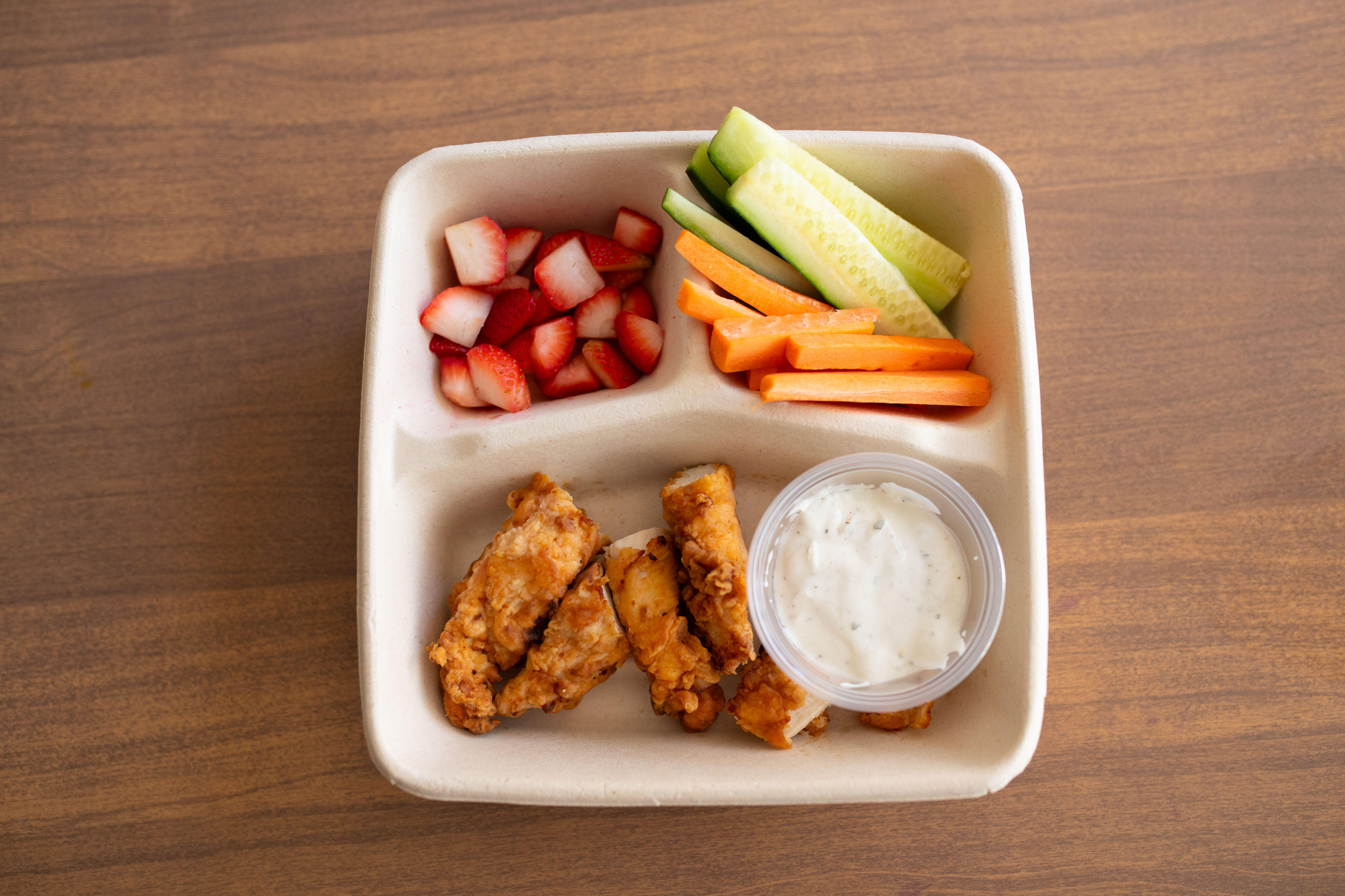 Lil' Bites Mighty Nuggets box with chicken nuggets, ranch, strawberries and veggie sticks