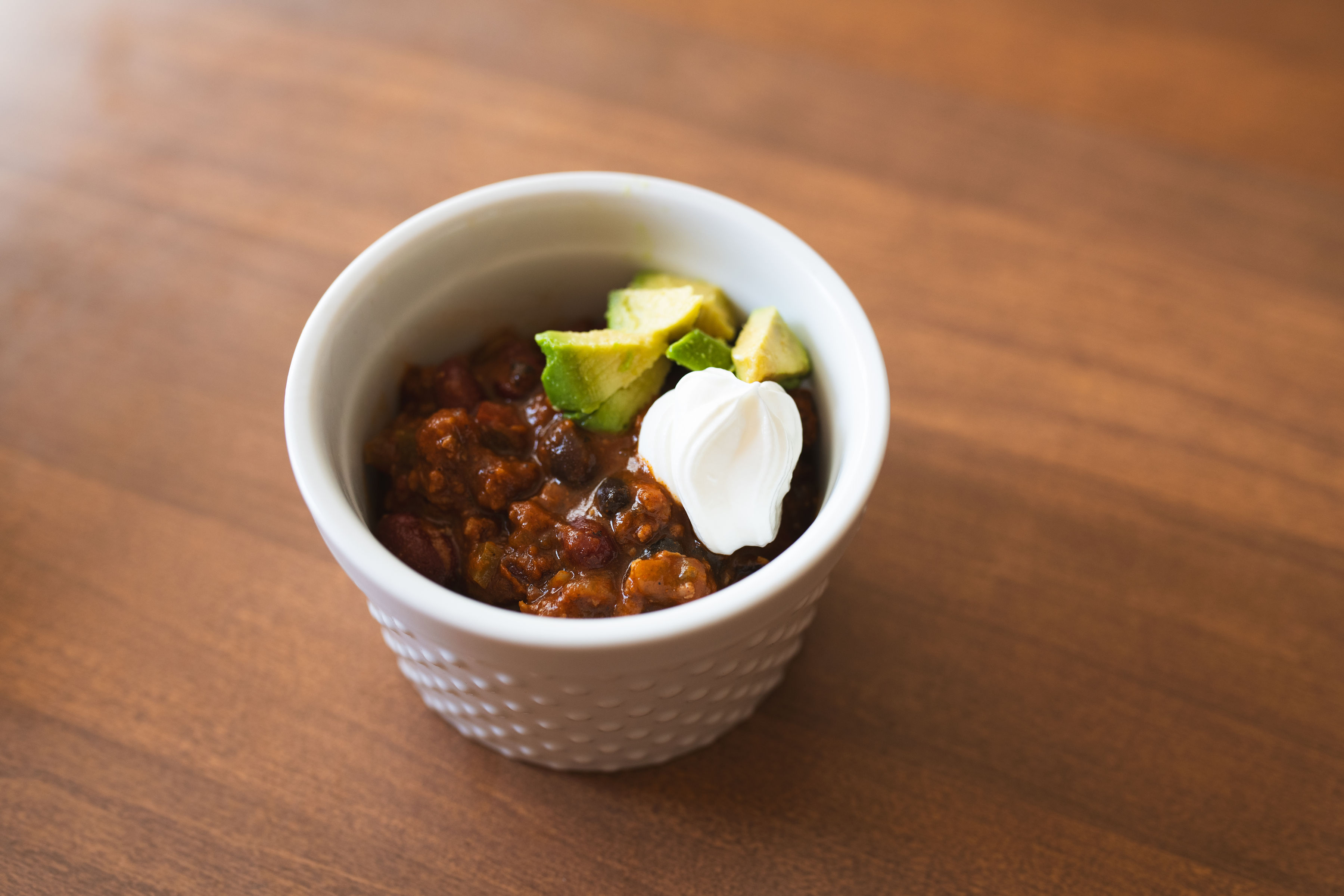 Colorado green chili burger bowl with ground beef, avocado and a dollop of sour cream