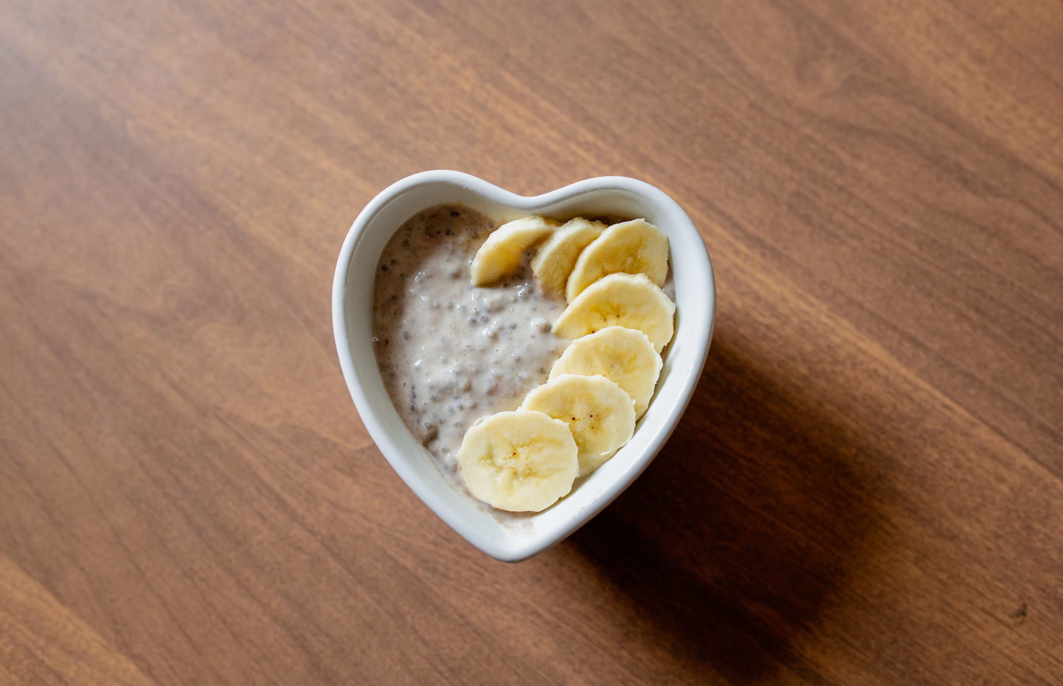 Banana maple chia pudding topped with fresh sliced banana