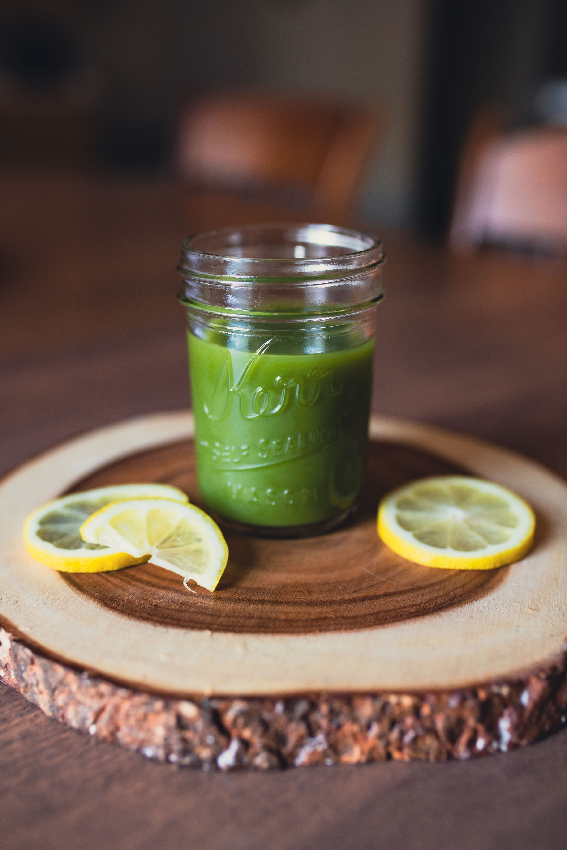 Power Greens juice — bright green pressed juice in a glass jar with lemon
