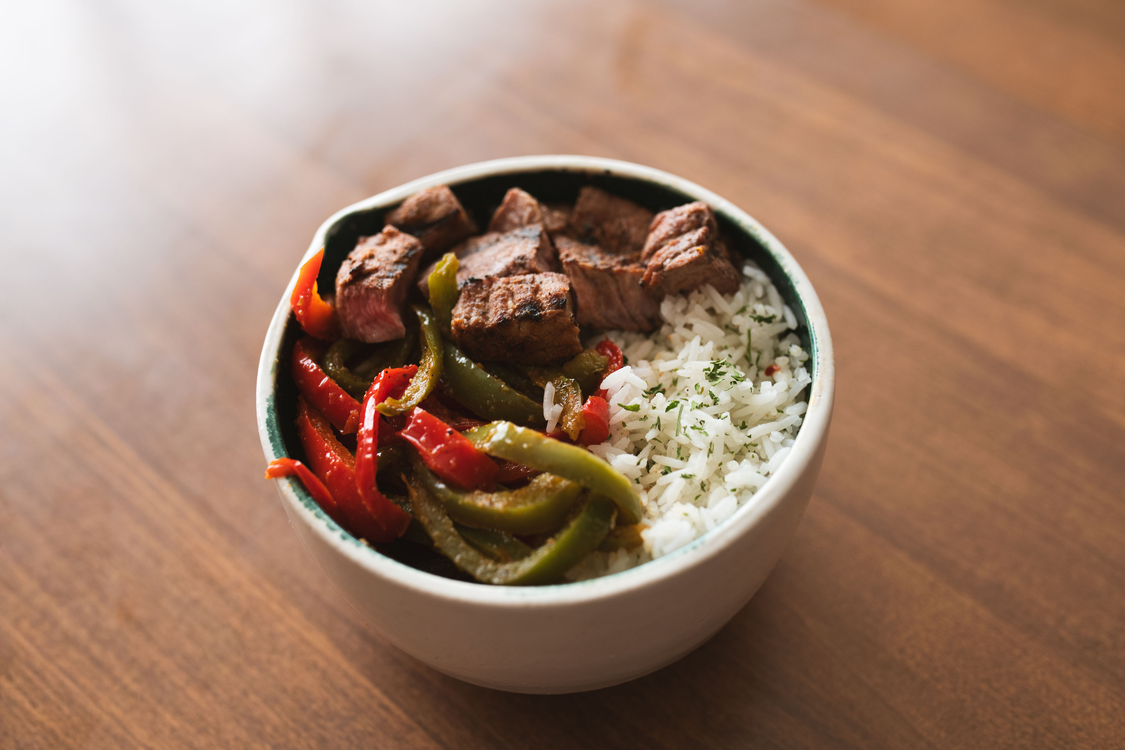 Fajita bowl with seared steak, sautéed bell peppers and jasmine rice
