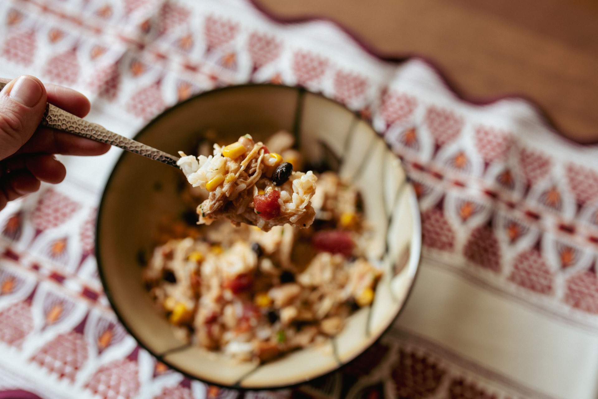 White chicken chili with shredded chicken, beans and corn over rice