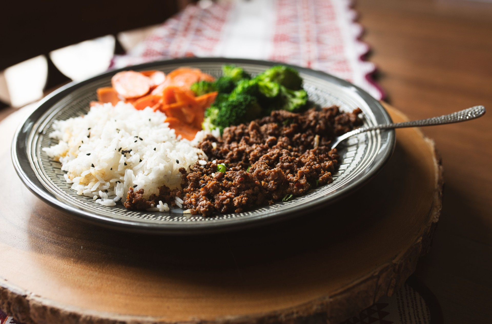 Korean beef bowl with sesame ground beef over rice with broccoli and carrots